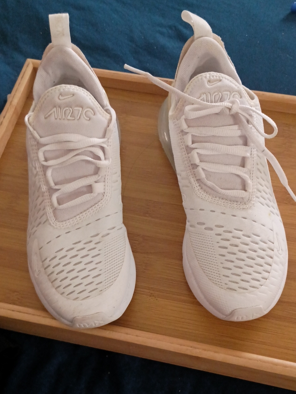 Nike Air Max 270 shoes in a white colorway, featuring a prominent, large
